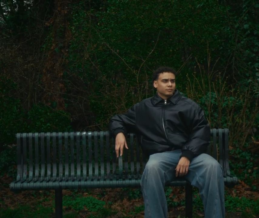 A photographer sitting on a bench.
